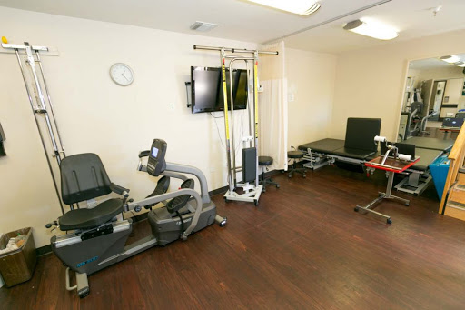 A well-equipped fitness and rehabilitation room featuring various exercise equipment.