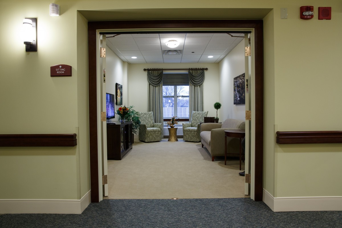 A cozy lounge area with comfortable seating and a large window.