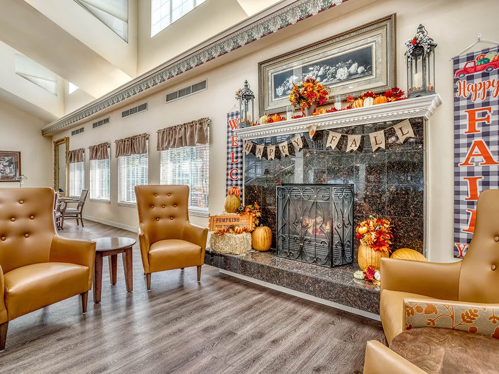 A cozy living room with a decorated fireplace and comfortable seating.