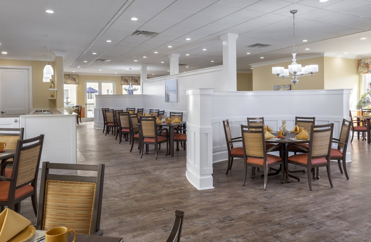 A modern restaurant dining area with neatly arranged tables and chairs.