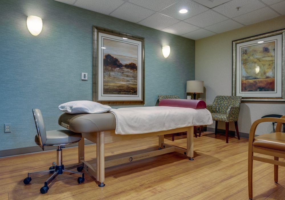 A tranquil massage therapy room with a neatly arranged massage table.