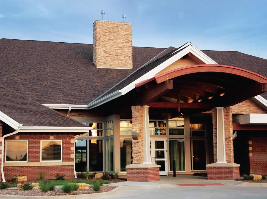 A modern building with a prominent entrance and brick exterior.