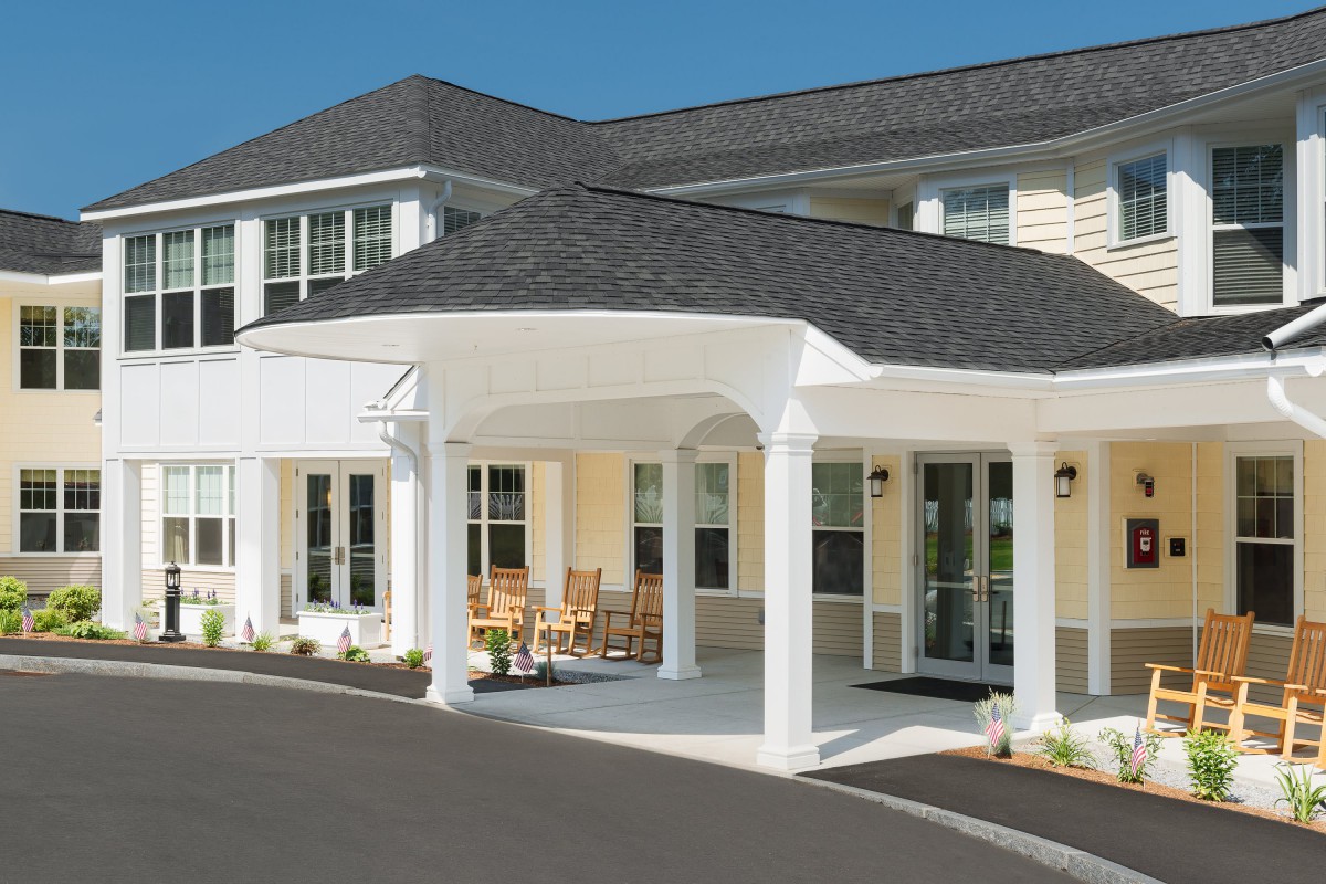 A residential building with a covered entrance and columns.