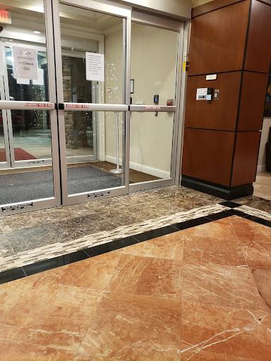 A well-designed lobby entrance featuring glass sliding doors and elegant flooring.