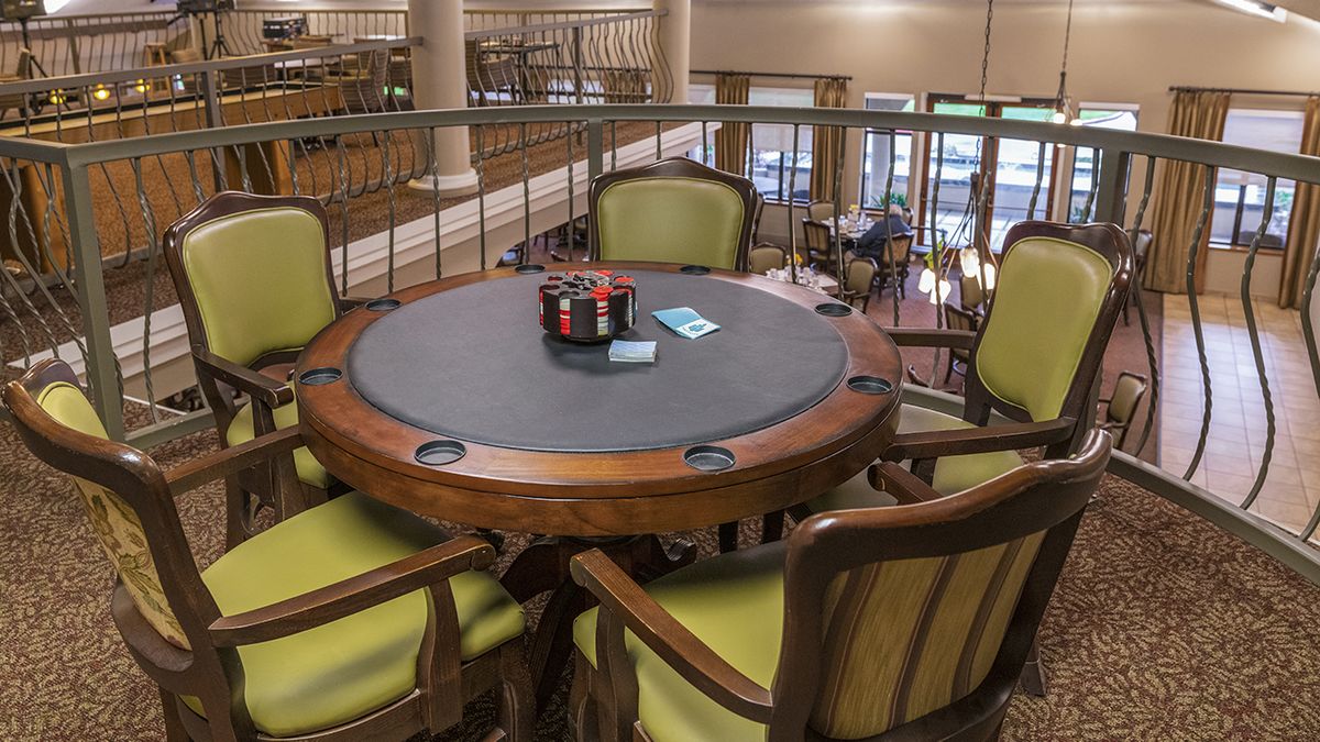 A poker table setup with cards and chips in a casino setting.