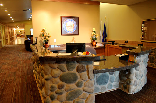 A welcoming reception area featuring a stone counter and decorative plants.