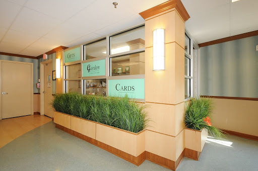 A modern lobby space featuring greenery and stylish lighting.