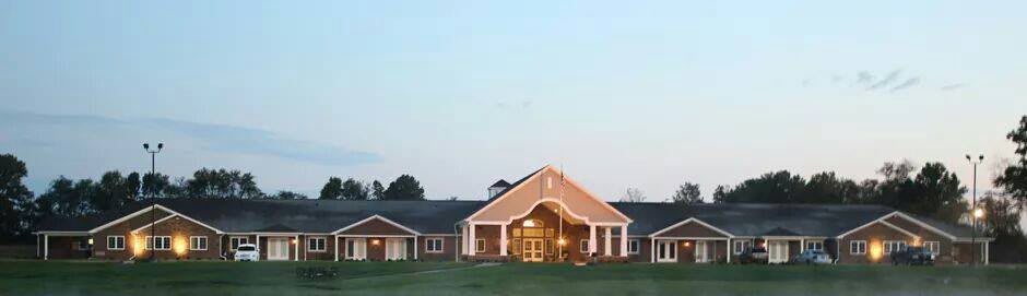 A community building with a welcoming entrance under a clear evening sky.