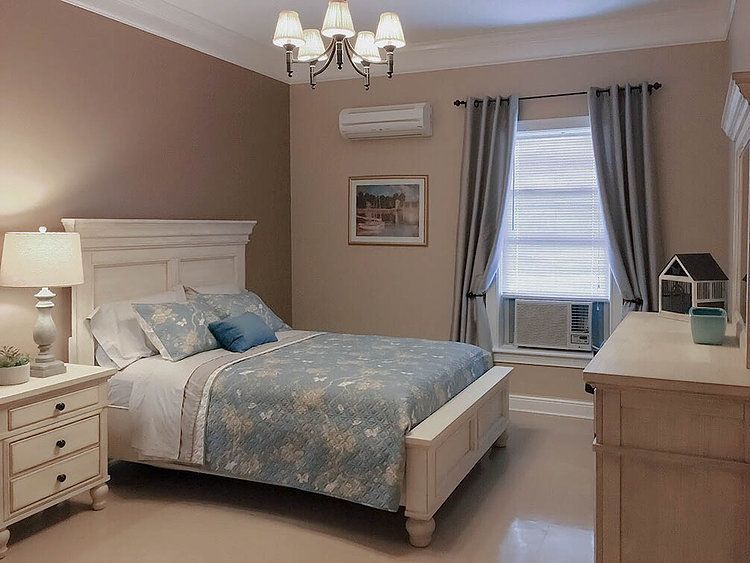 A cozy bedroom with classic furniture and soft lighting.
