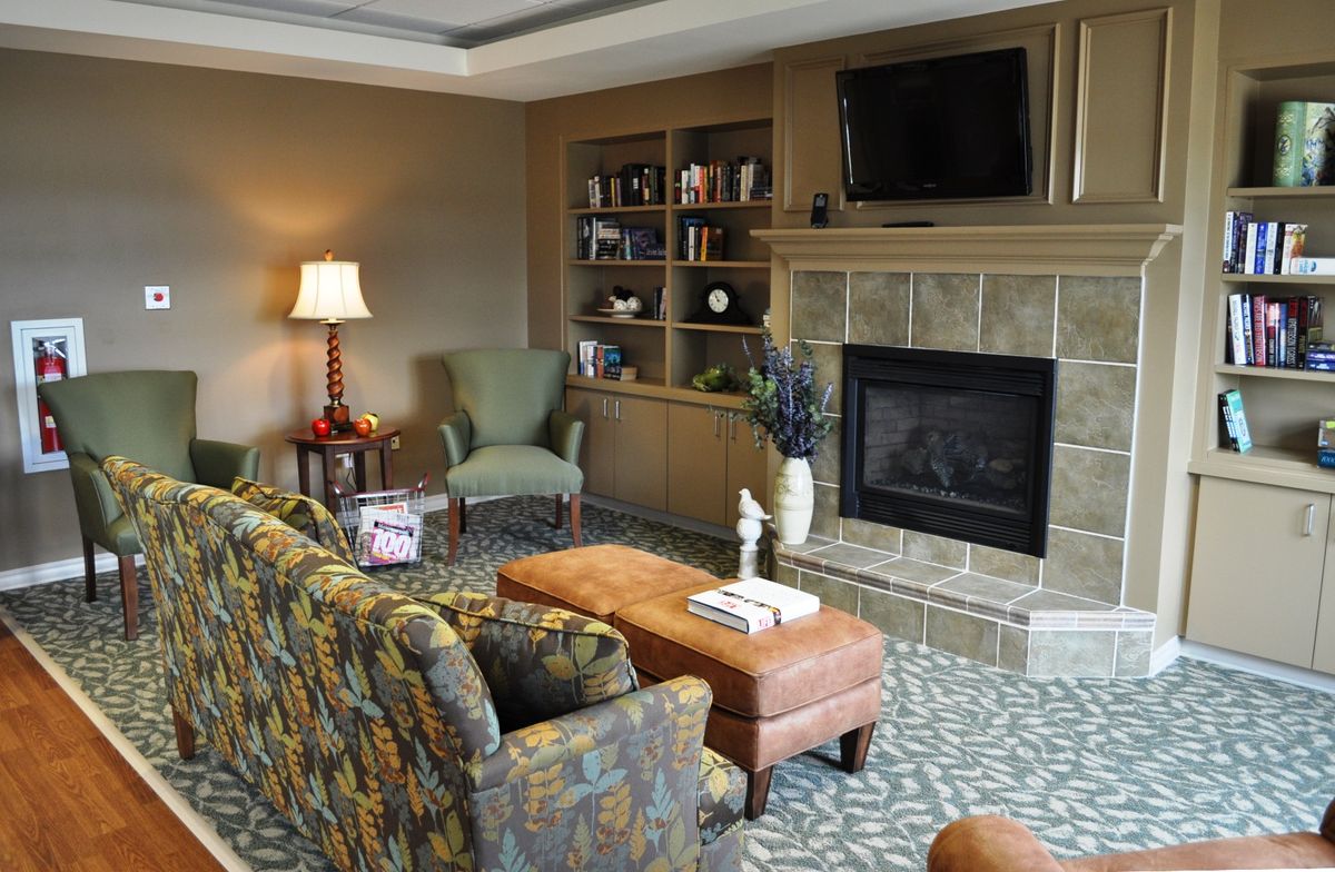 A cozy living room with a fireplace, comfortable seating, and a television.