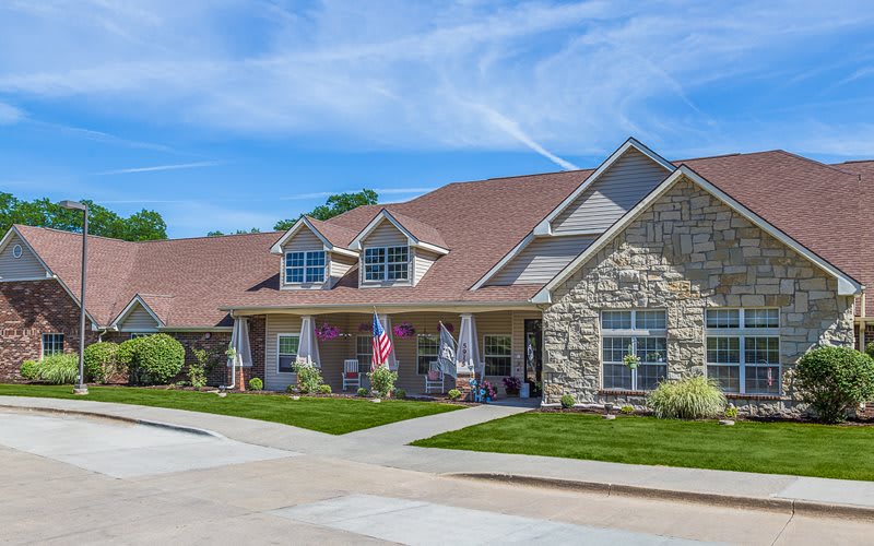 A picturesque suburban house with a well-maintained lawn and driveway.