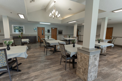 A spacious and modern dining area with elegantly set tables and comfortable seating.