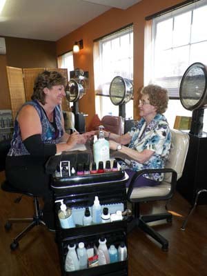 Two people enjoying a manicure session in a nail salon.