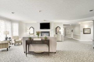 A modern and bright living room with a fireplace and television.