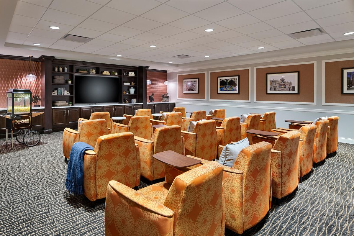 A luxurious home theater with comfortable seating and a large screen.