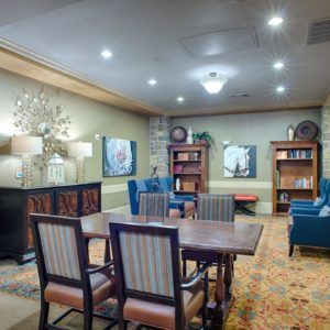A cozy living room with a dining area, featuring comfortable furniture and decorative lighting.