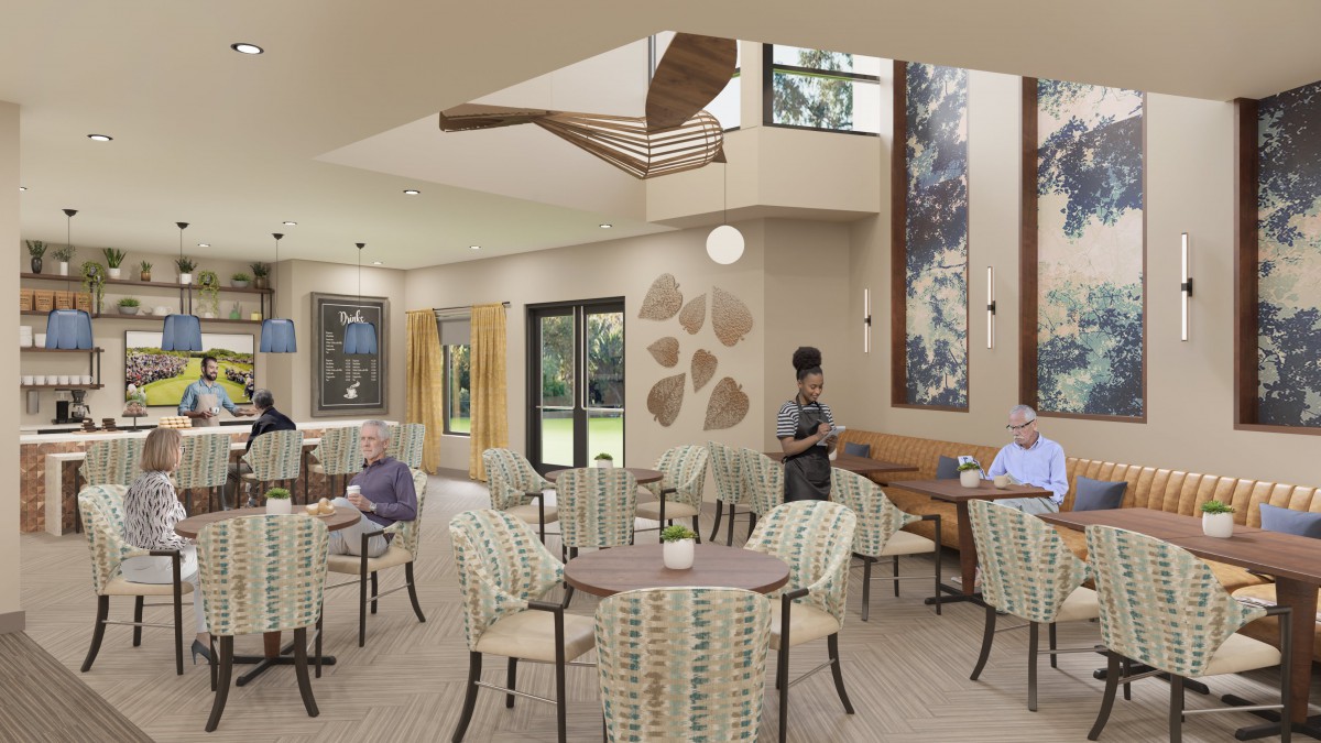 A modern lounge area with seating and artwork, featuring people interacting in a well-lit space.