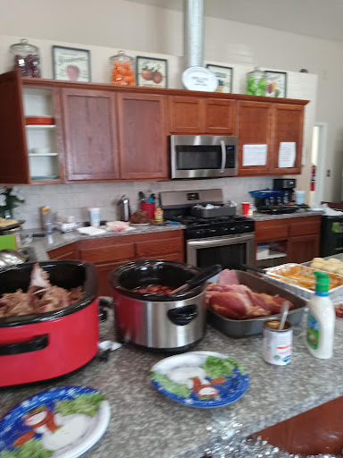 A bustling kitchen filled with various cooking appliances and ingredients, showcasing a lively food preparation scene.
