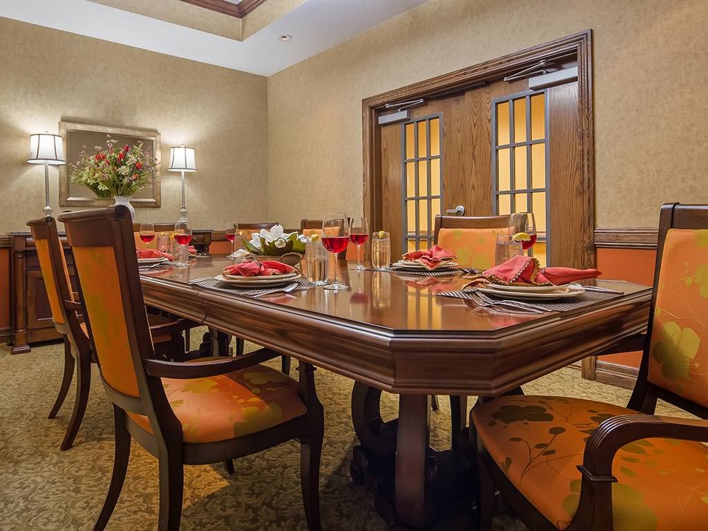 A elegantly set dining room with wooden furniture and stylish decor.