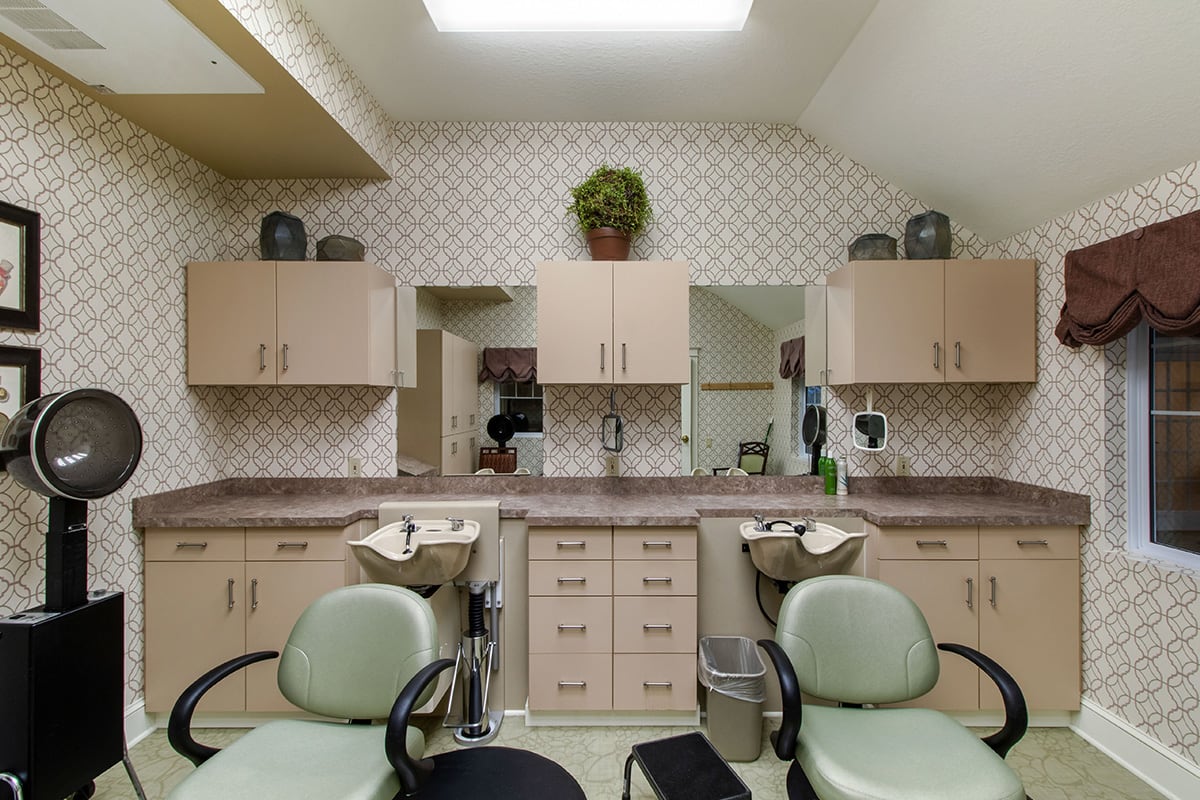 A well-organized hair salon interior with chairs, sinks, and mirrors.