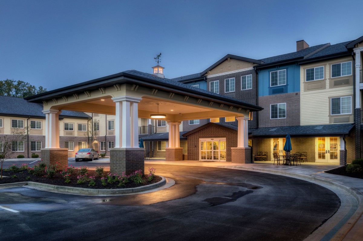A well-lit hotel entrance during the evening.