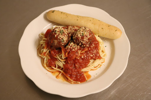 A delicious plate of spaghetti with meatballs in tomato sauce, accompanied by a breadstick.