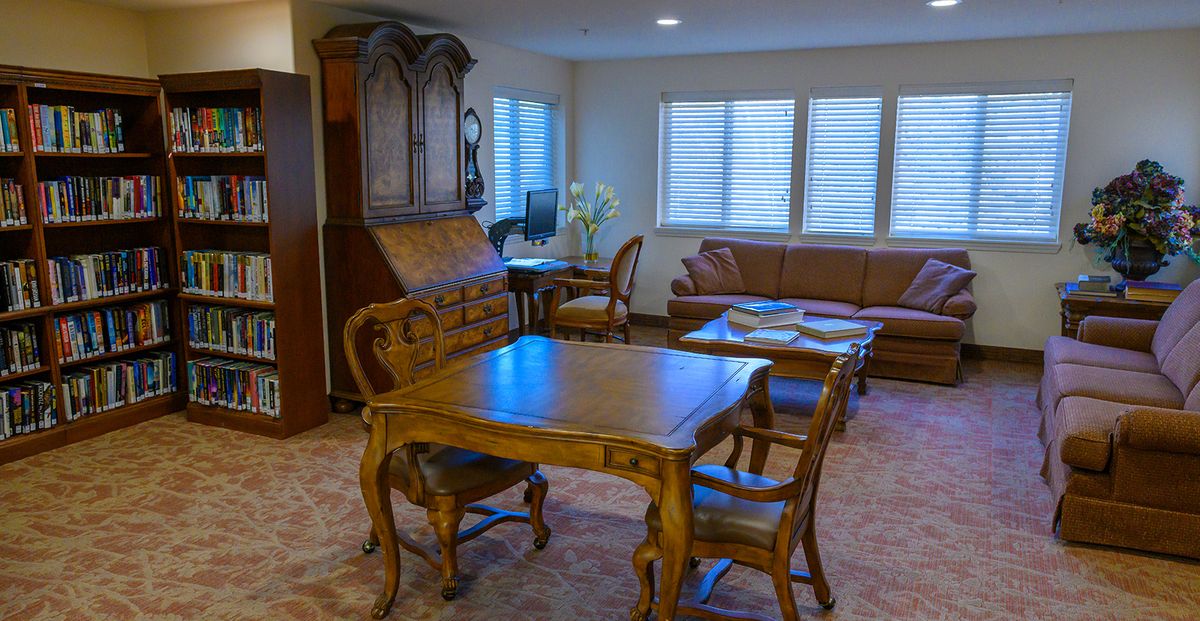 A cozy living room with antique wooden furniture and a warm ambiance.