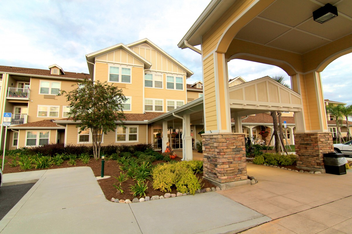 A view of a residential building with landscaped surroundings and an inviting entrance.