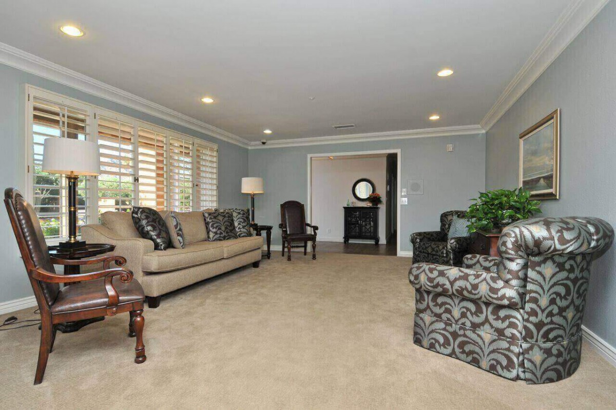 A spacious living room with comfortable seating and elegant decor.