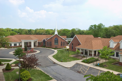 A serene view of a church complex surrounded by lush greenery.