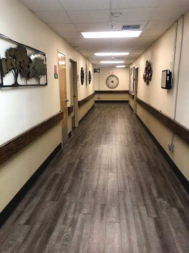 A well-lit hallway featuring decorative wall art and modern flooring.