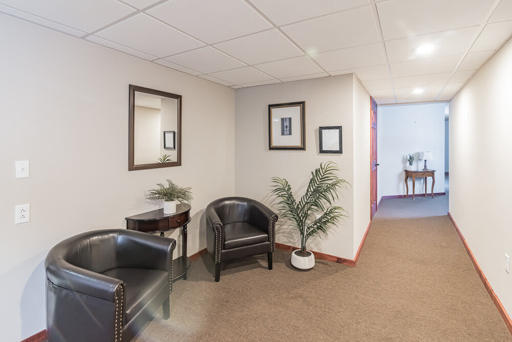 A professional waiting area with seating and decorative elements in an office setting.