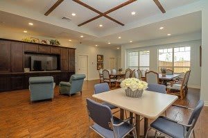 A spacious living and dining area with wooden flooring and comfortable furniture.