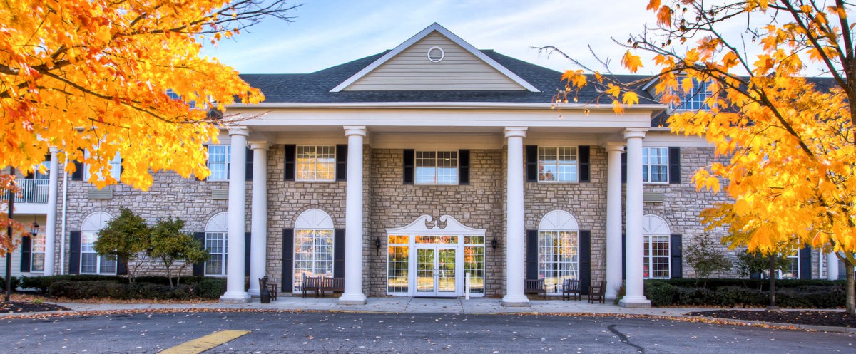 A classical building with prominent columns and symmetrical windows.