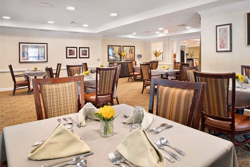 An elegant dining room with neatly arranged tables and chairs, ready for guests.
