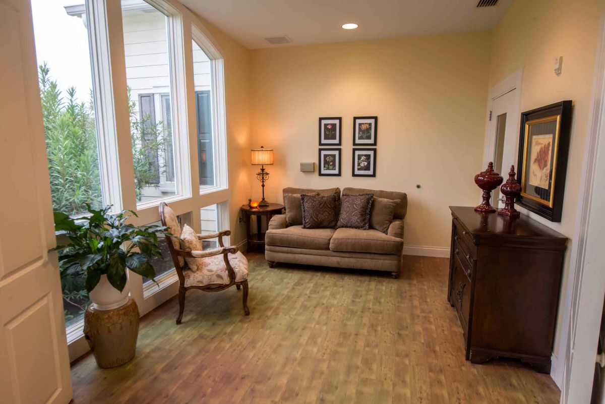 A cozy living room with a sofa, armchair, and decorative elements.