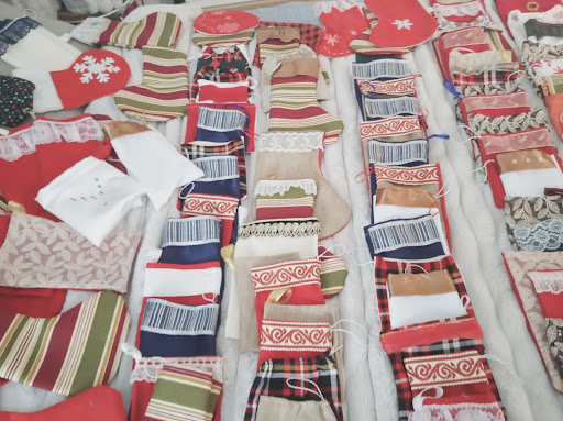 A colorful assortment of fabric pieces laid out for a holiday crafting project.