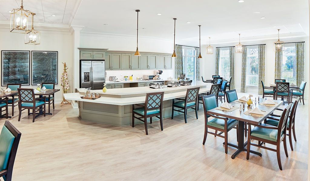 A modern kitchen with an open layout featuring a large island and adjacent dining area.