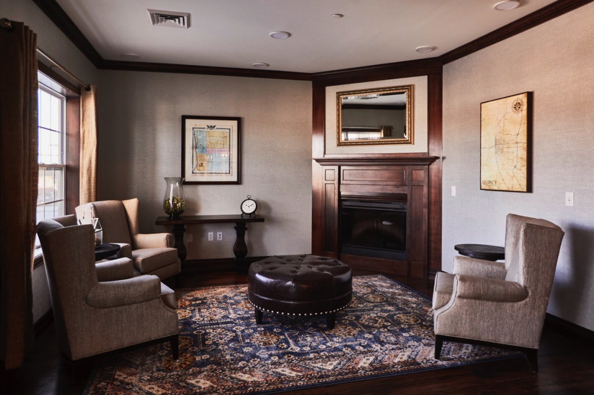 A cozy living room with comfortable seating, a fireplace, and elegant decor.