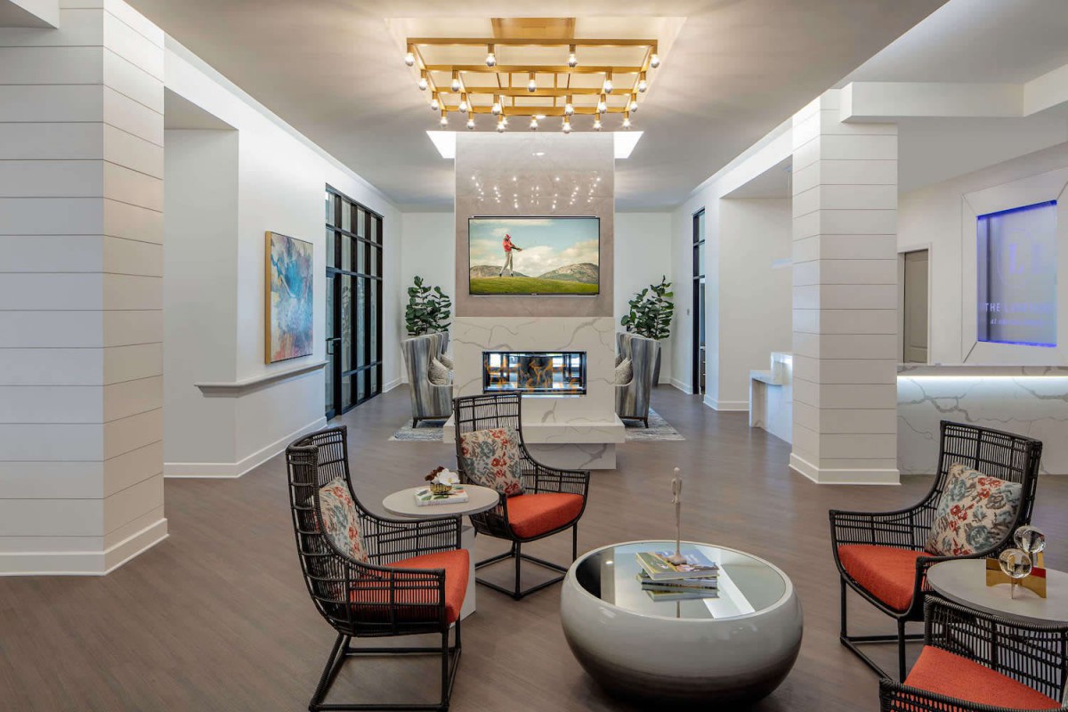 A modern living room with stylish furniture and a fireplace centerpiece.