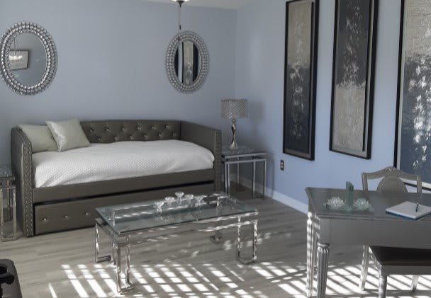 A modern bedroom featuring a daybed, glass table, and contemporary artwork on the walls.