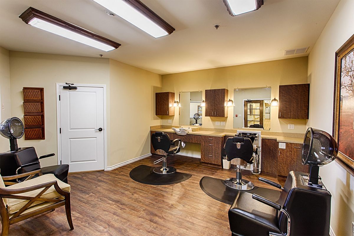 A modern hair salon with stylish barber chairs and well-lit mirrors.