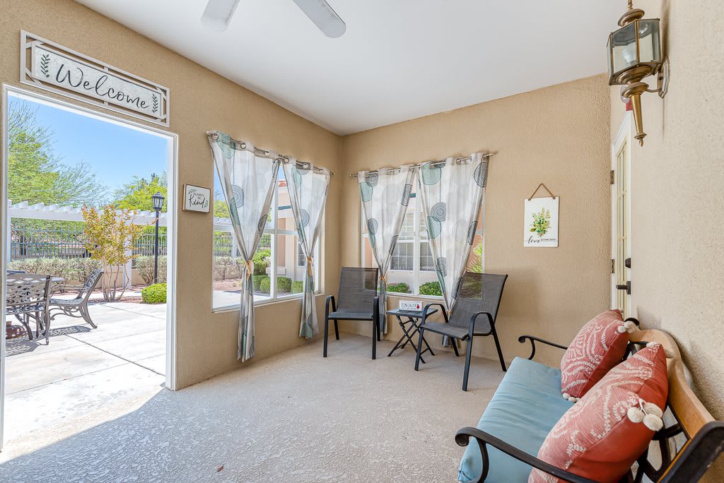 A cozy sunroom with natural light and a view of the patio.