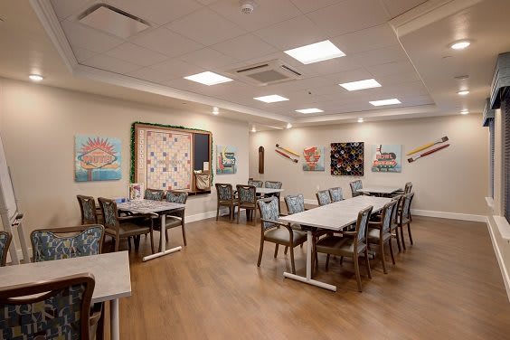 A modern dining area with artwork displayed on the walls.