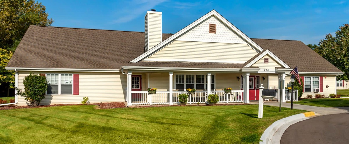 A suburban house with a well-maintained lawn and a cozy porch.