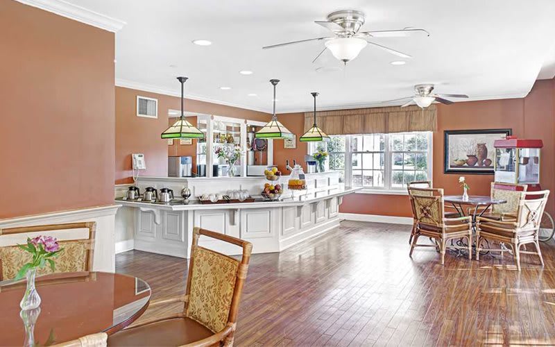 A spacious, modern kitchen with an open dining area featuring pendant lights and hardwood flooring.