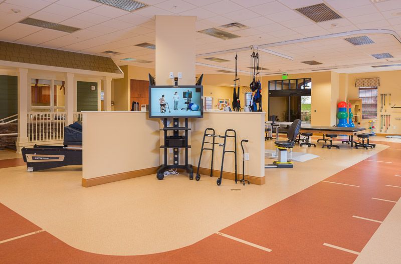 A physical therapy room equipped with various exercise and rehabilitation tools.