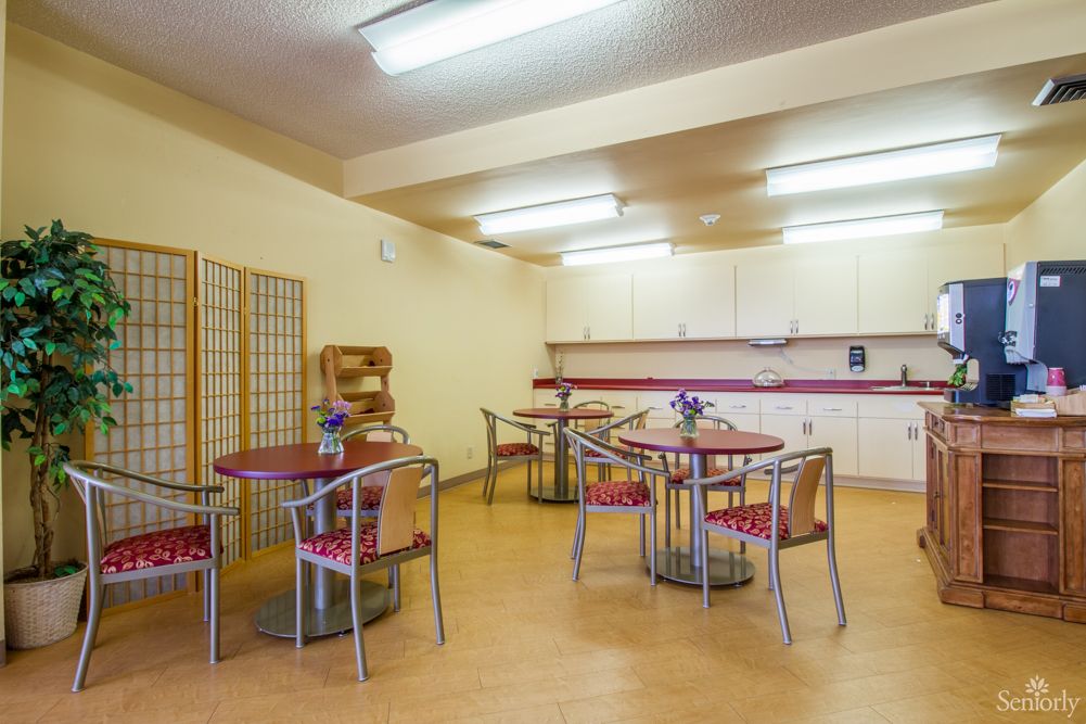 A spacious kitchen and dining area with modern furniture and bright lighting.