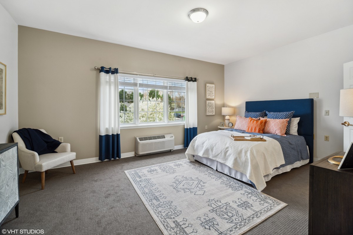 A modern and spacious bedroom with stylish decor and ample natural light.