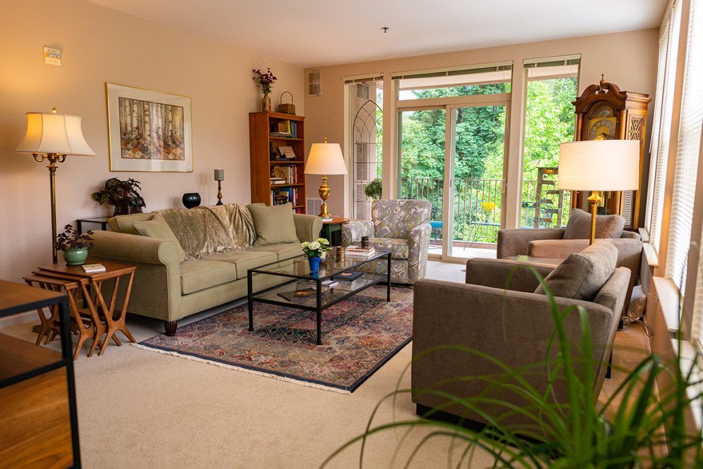 A cozy living room with stylish furniture and a view of the garden.
